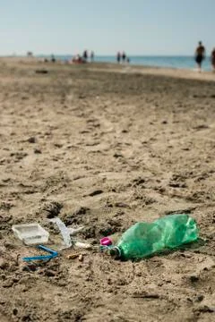 Plastic garbage left on a sandy beach. Stock Photos