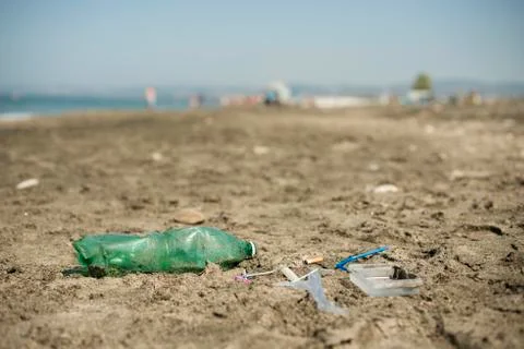Plastic garbage left on a sandy beach. Stock Photos