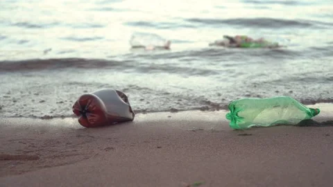 Plastic garbage lying on the beach Stock Footage 136471425