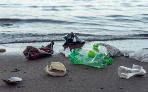 Plastic garbage lying on the beach Stock Photos