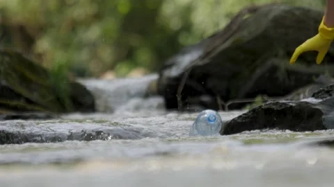 Plastic garbage in nature clean up waste water. Volunteer hands picks up a Stock Footage 158510065