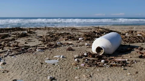 Plastic garbage on polluted beach over sea waves motion,dirty planet ecosystem Stock Footage 120465720