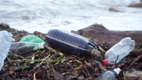 Plastic garbage polluting the sea beach. Video stock 246880498