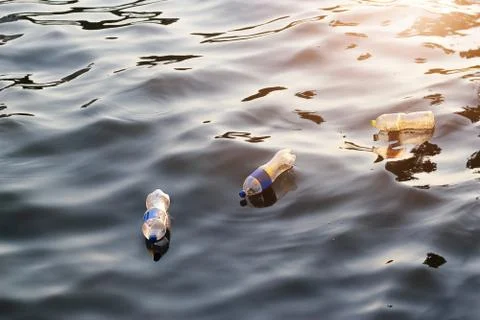 Plastic garbage in river sunset, pollution and environment concept Stock-Fotos