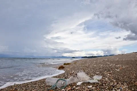 Plastic garbage thrown to the seashore. Stock Photos