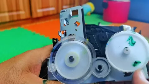 Plastic Gear Mechanism with Interlocking Cogs in Motion Stock Footage 333548412