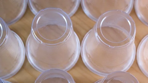 Plastic glass used for drinking water in row - Environmental problem concept Stock Footage 123967716