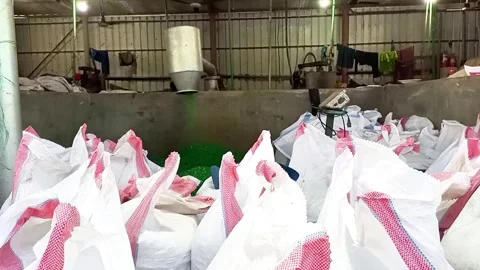 Plastic granules being processed in an industrial recycling plant using machines Stock Footage 318694605