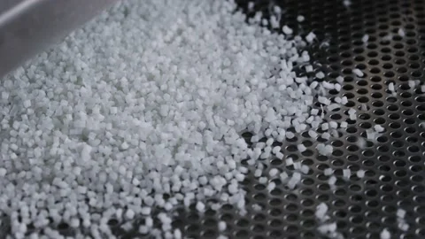 Plastic granules on a vibrating table. Polymer compound production Stock Footage 160351659