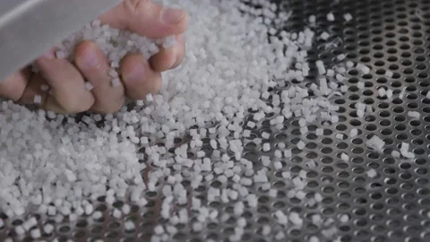 Plastic granules on a vibrating table. Polymer compound production Stock Footage 160391266