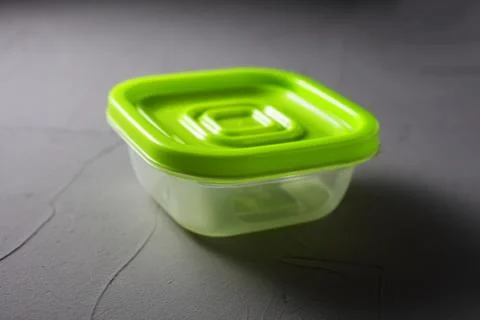 Plastic green food container on bitmap background soft focus Foto stock