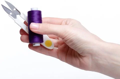 Plastic handle sewing thread cutter in hand Stock Photos