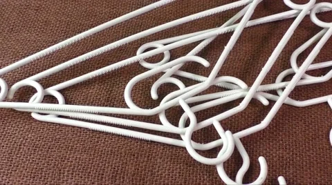 Plastic hangers  on the brown background Stock Footage 60771336