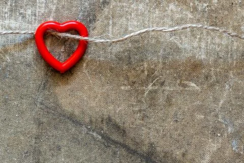 Plastic heart hanging on the string Stock Photos