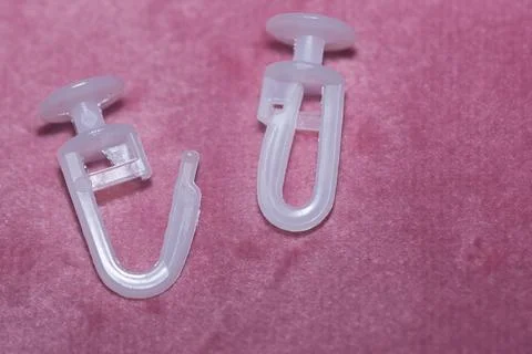 Plastic hooks for ceiling cornices Foto stock
