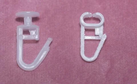 Plastic hooks for ceiling cornices, white-collar. Stock Photos
