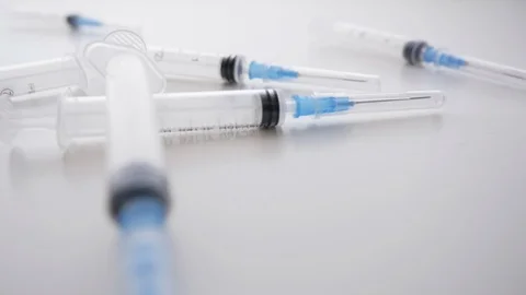 Plastic Hypodermic Needles Fall into a Large Pile in Slow Motion Stock Footage 112474761