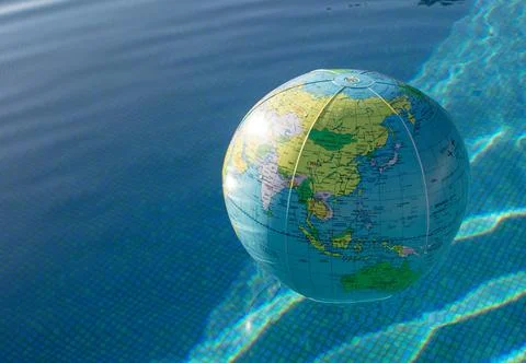 Plastic, inflatable globe floating in a swimming pool Stock Photos