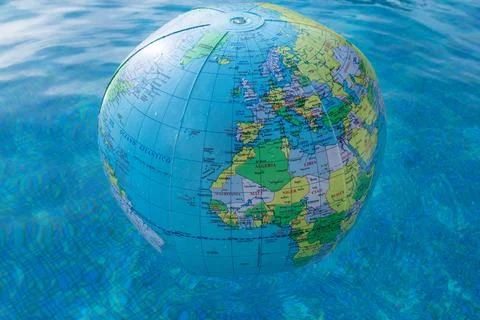 Plastic, inflatable globe floating in a swimming pool Stock Photos