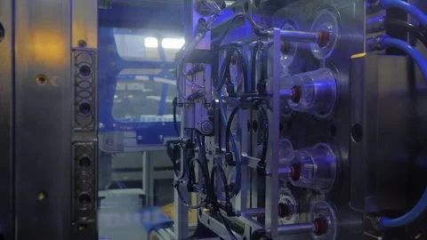 Plastic injection molding machine is making sauce cups, containers - close up Stock Footage 337061613