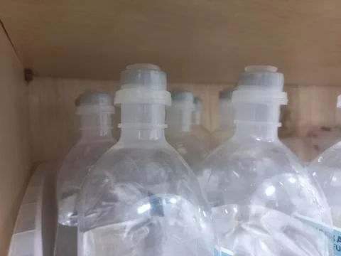 Plastic IV Infusion Bottles on Storage Shelf in Hospital Closet Stock Photos