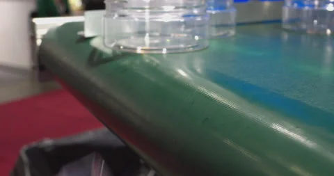 Plastic jars falling off conveyor belt in production line Video stock 329182019