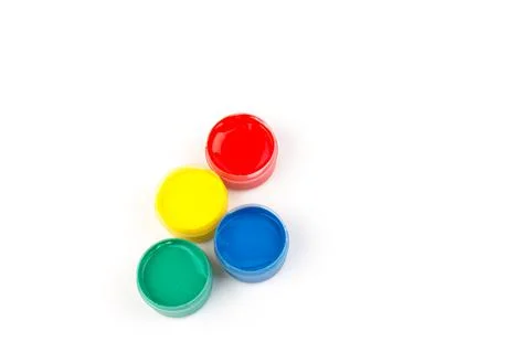 Plastic jars with paint of different colors for children's creativity on whit 스톡 사진