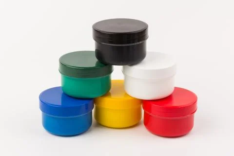 Plastic jars with paint of different colors for children's creativity on whit Stock Photos