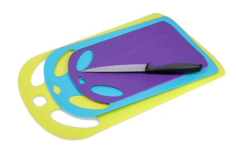 Plastic kitchen cutting board with knife isolated on the white Stock Photos