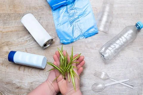 Plastic kitchenware utensils, bottle, cellophane bag, can, cups. Woman hold.. Stock Photos