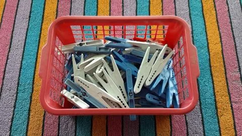 Plastic laundry clips in the small box Stock Photos