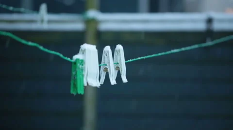 Plastic laundry clothes pins or clips in a snowy day Video stock 45419970