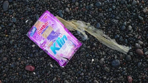 Plastic Laundry Detergent Package on Black Sand, Bali Stock Footage 147286390