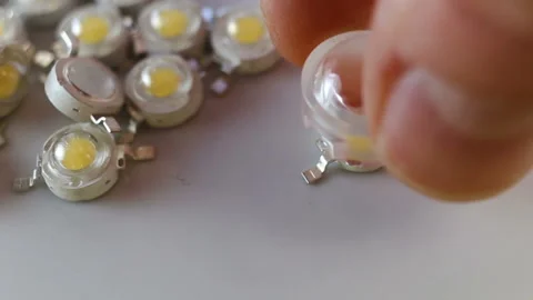 Plastic lens for cree LEDs close-up, real time. The lens is put on a new non-sol Stock Footage 129770756