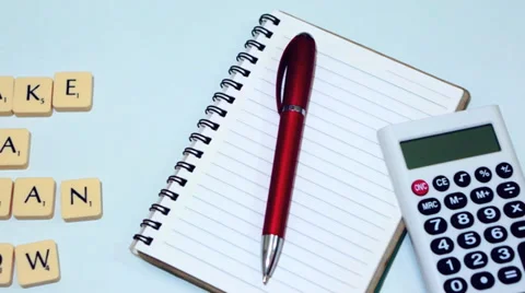 Plastic letter pieces with calculator, notepad and red pen Stock Footage 39363101