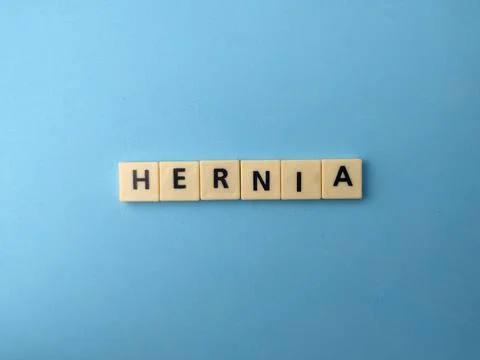 Plastic letter tiles centered on a solid light blue background spell out th.. Stock Photos