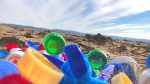 Plastic lids on the beach Stock Footage 161696459