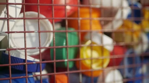 Plastic lids from bottles in a container. garbage. ecology Stock Footage 260416957