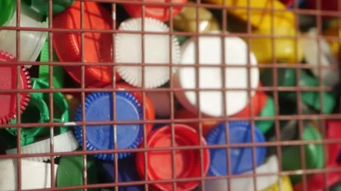 Plastic lids from bottles in a container. garbage. ecology Stock Footage 260417072