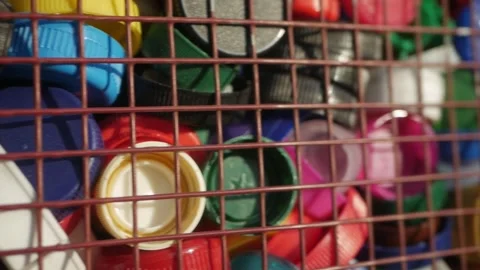 Plastic lids from bottles in a container. garbage. ecology Stock Footage 260417192