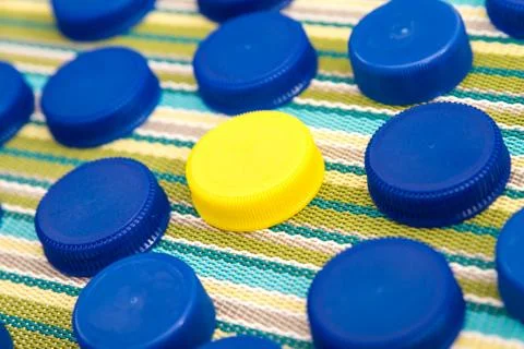 Plastic lids, one in a different color Stock Photos