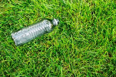 Plastic litter on grass. Stock Photos