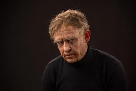 Plastic makeup. makeup for cinema. old man on a black background Stock Photos