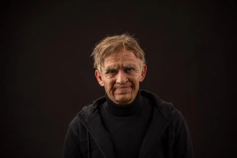 Plastic makeup. makeup for cinema. old man on a black background Stock Photos