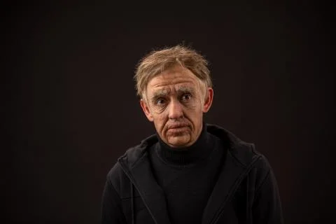 Plastic makeup. makeup for cinema. old man on a black background Stock Photos