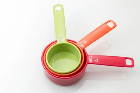 Plastic measuring cups isolated on white background. Stock Photos