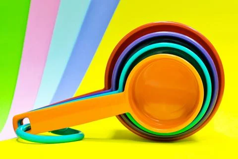 Plastic measuring cups stacked multicolor. Stock Photos