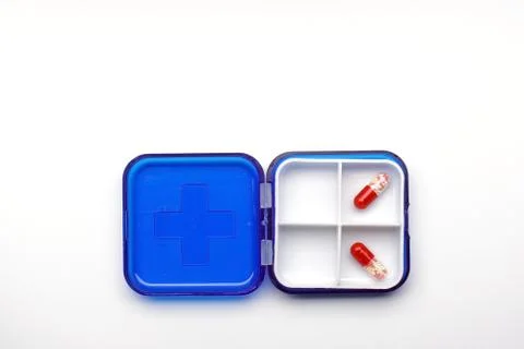 Plastic medicine diary with two capsules, box with two capsules for tablets top Stock Photos