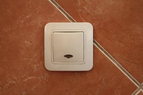 Plastic modern light switch button on wall Stock Photos