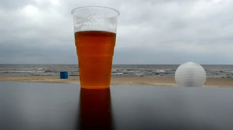 Plastic mug beer stand beach pub table background sea Stock Footage 22565718